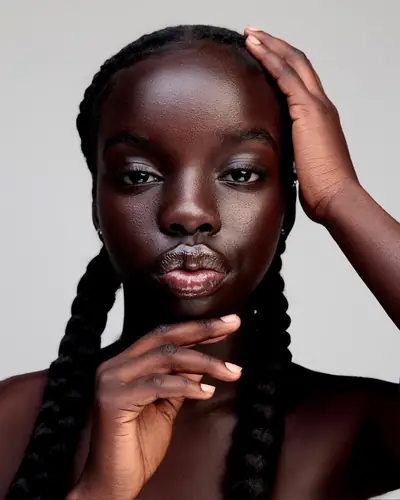 Beauty portrait of Joy with her hand in her braids