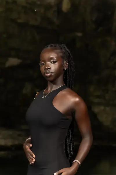 Joy in a black tank top at night outdoors